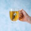 Www-Teas-Co-Uk-Good-Earth-Elderflower-And-Pear-White-Tea-15-Tea-Bags-18G-5000208052097-Brewed-Tea-In-Clear-Chunky-Glass-Cup-Lifestyle Good Earth Elderflower And Pear White Tea, 15 Tea Bags 18G