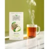 Www-Teas-Co-Uk-Good-Earth-Elderflower-And-Pear-White-Tea-15-Tea-Bags-18G-5000208052097-Front-Of-Box-Next-To-Hot-Tea-In-Clear-Glass-Cup Good Earth Elderflower And Pear White Tea, 15 Tea Bags 18G