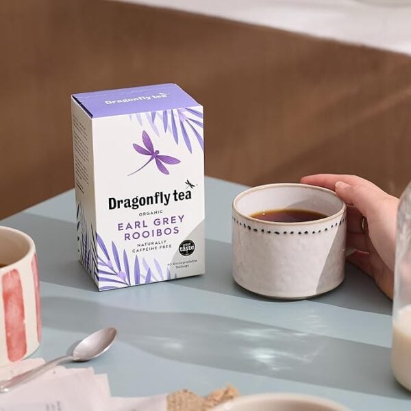 Dragonfly Organic Earl Grey Rooibos, 40 Tea Bags 100G, Front Of Box With Tea In Mug On Table In A Lifestle, Available At Teas.co.uk