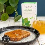 Dragonfly Organic Pure Green Mountain, 40 Tea Bags 80g, lifestyle with tea in cup on table with toast on plate, available at teas.co.uk