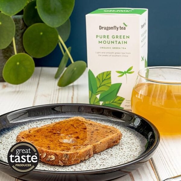 Dragonfly Organic Pure Green Mountain, 40 Tea Bags 80G, Lifestyle With Tea In Cup On Table With Toast On Plate, Available At Teas.co.uk