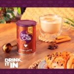 Drink Me Chai Dirty Chai Latte, 200g, jar on table with latte in lifestle, available at teas.co.uk