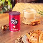 Drink Me Chai Spiced Chai Latte, 250g, front of jar in lifestly on table with latte, available at teas.co.uk