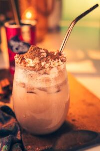 Drink Me Chai Spiced Chai Latte, 250g, iced latte in tall clear glass with cream and straw, available at teas.co.uk