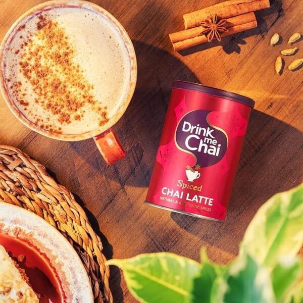 Drink Me Chai Spiced Chai Latte, 250g, jar on table with latte lifestyle, available at teas.co.uk
