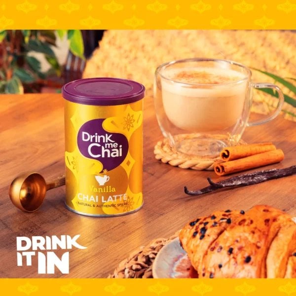 Drink Me Chai Vanilla Chai Latte, 250g, front of jar in lifestyle view on table, available at teas.co.uk