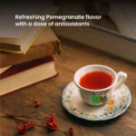 Twinings Pomegranate Green Tea, 20 Tea Bags 40g, brewed tea in cup and saucer, available at teas.co.uk