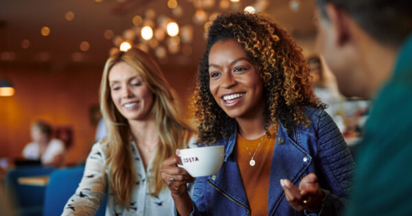 Costa Intense Dark Roast Coffee, 100g, lifestyle mug in ladies hand, available at teas.co.uk