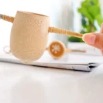 Tunta Bamboo Tea Strainer, Handmade in Thailand, close up in hand, available at teas.co.uk