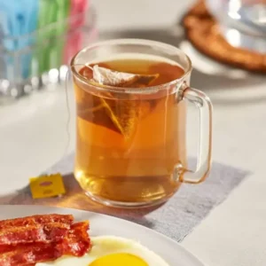 Lipton Black Tea with Spanish Lemons, 20 Tea Bags 34g, tea brewing with tea bag in glass mug, available at teas.co.uk