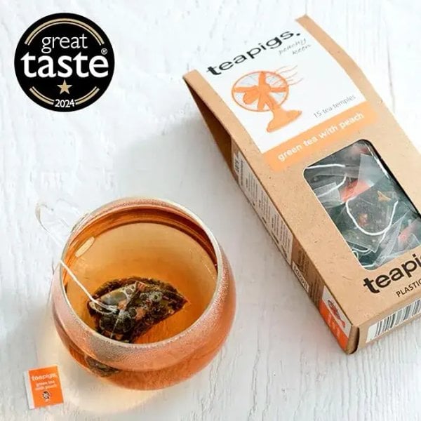 Teapigs Green Tea With Peach, 15 Tea Bags 37.5G, Top View With Tea Brewing In Clear Glass, Available At Teas.co.uk